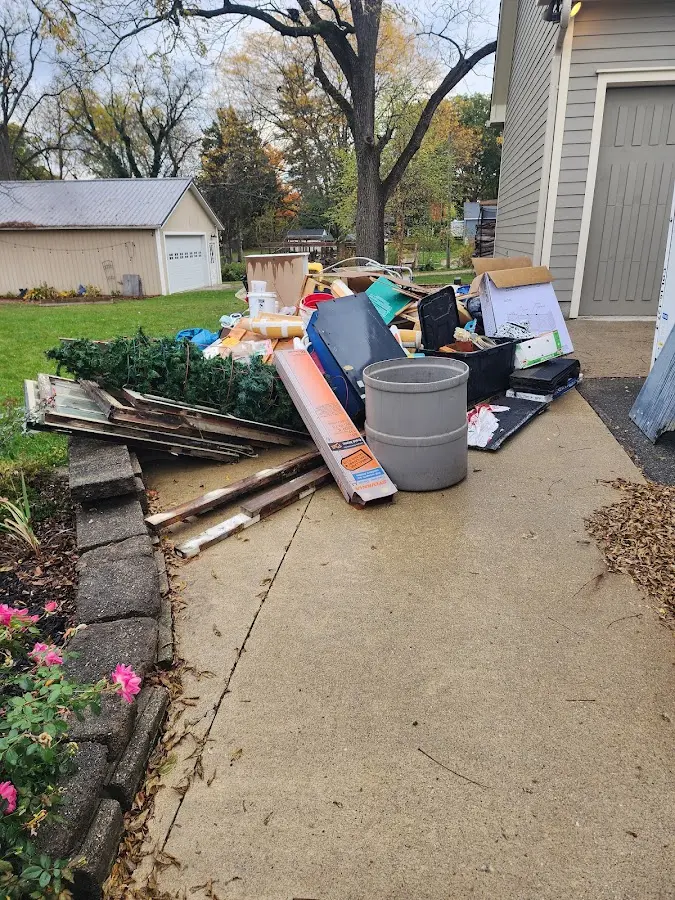 Dumpster being loaded with debris for Estate Cleanout Dumpster Rental in Sheridan